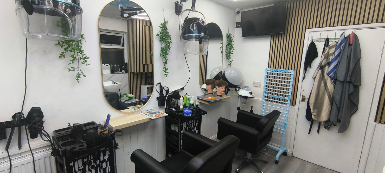 Selam Unisex Hair Salon hair studio — professional styling chairs and round arched mirrors