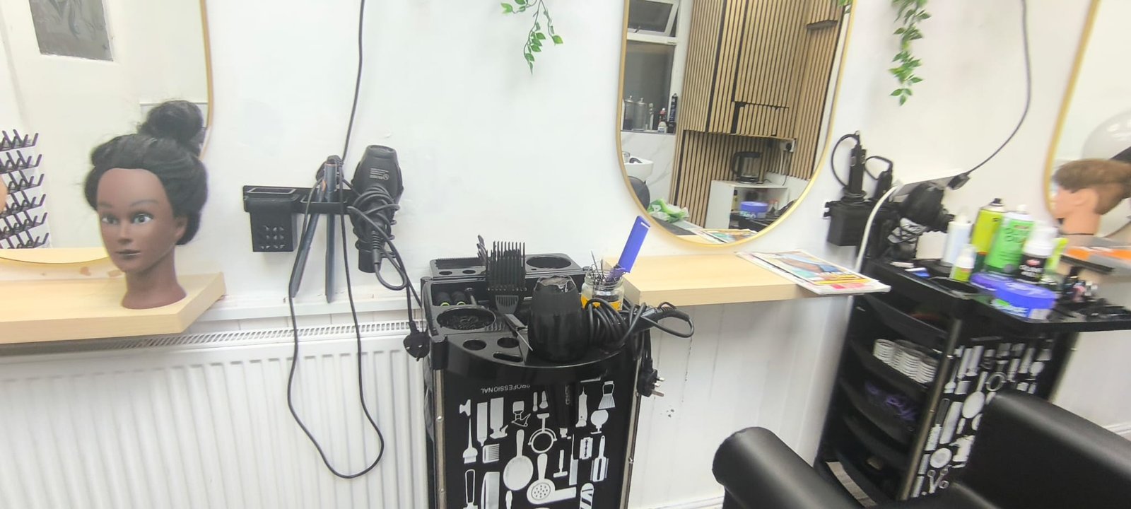 Selam Unisex Hair Salon hair studio — styling station with mannequin head and tools